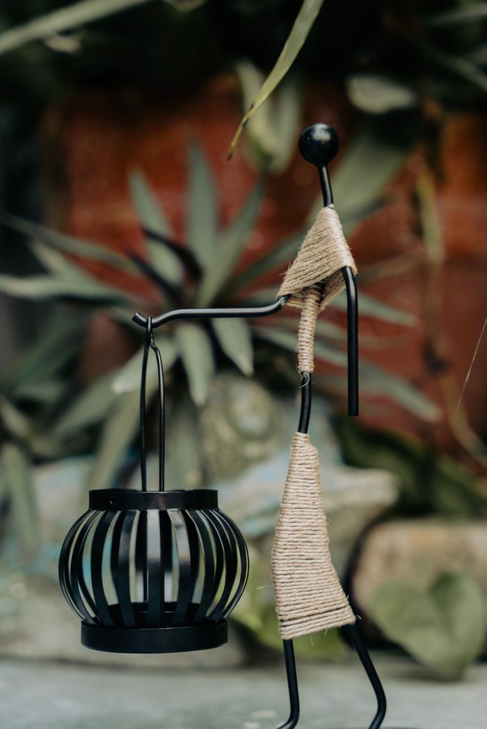 services-01 Stylish metal sculpture with a lantern, perfect for home and garden decor.