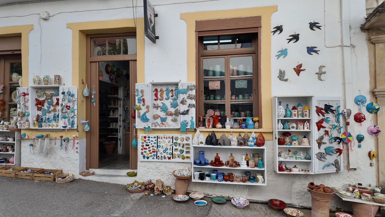 trusted-partner Charming outdoor display of handcrafted ceramics at a shop in Margarites, Greece.