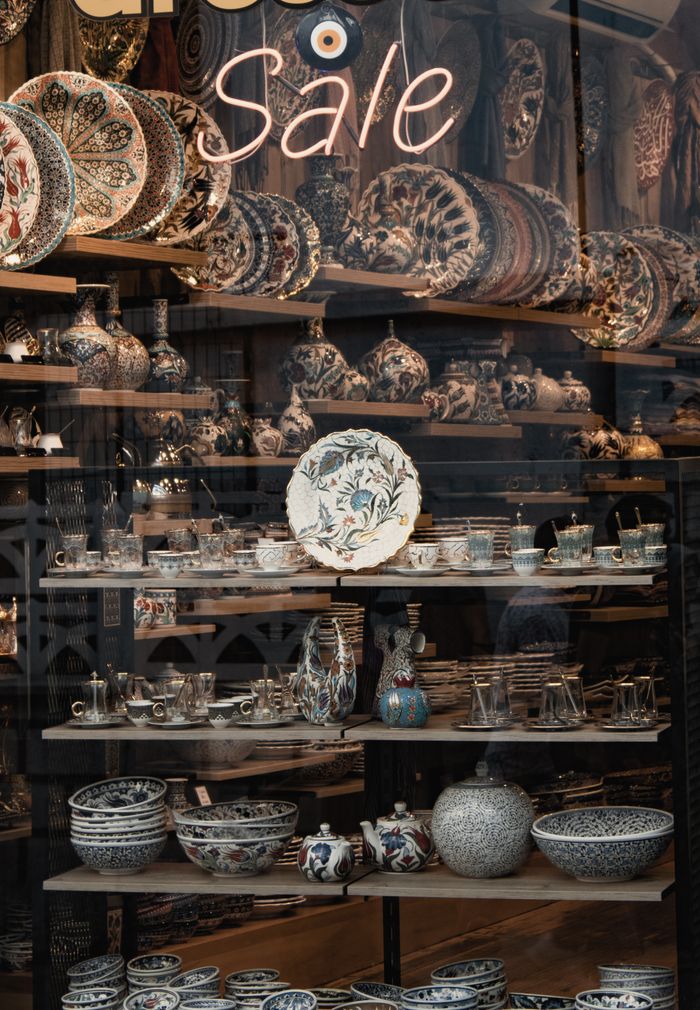 services-01 Beautiful assortment of ceramic pottery displayed in a shop window during a sale event.